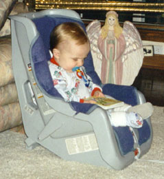 Alexander reading while in his car seat
